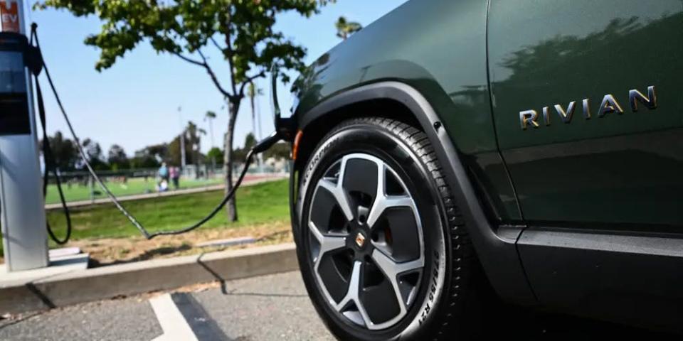 A Rivian charging at an EV charging station