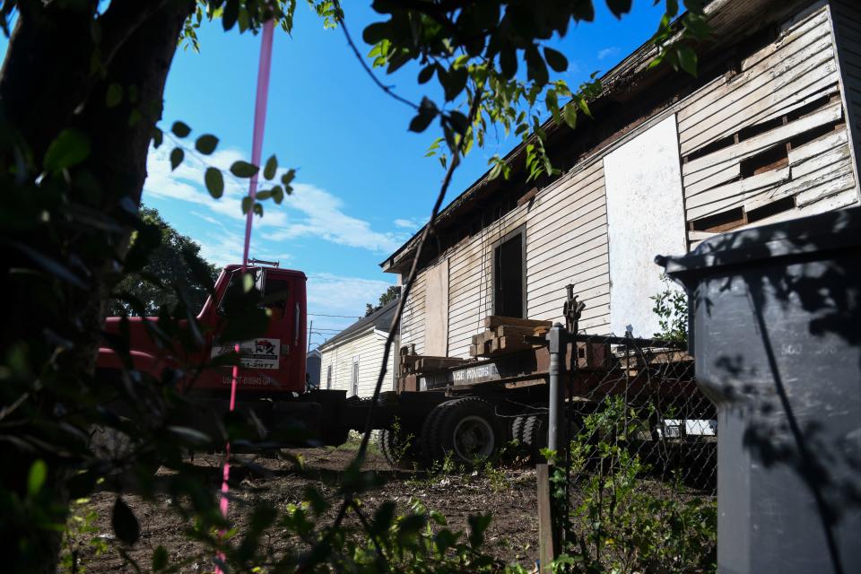 Workers with Fish Brothers House Movers transport the historic Fordyce-Kennedy-Pritchard House from McDowell Street to its new location on East Avenue on Thursday, Sept. 7, 2023.