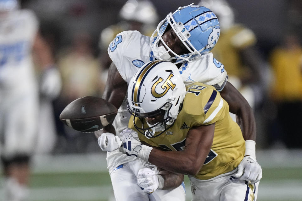 North Carolina wide receiver Devontez Walker (9) fumbles as he is hit by Georgia Tech defensive back Ahmari Harvey (18) during the second half of an NCAA college football game, Saturday, Oct. 28, 2023, in Atlanta. (AP Photo/John Bzemore)