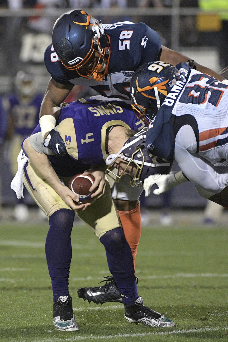 Atlanta Legends quarterback Matt Simms (4) is sacked by Orlando Apollos linebacker Christian French (58) and Josh Banks Sr. (92) during the first half of an Alliance of American Football game Saturday, Feb. 9, 2019, in Orlando, Fla. (AP Photo/Phelan M. Ebenhack)