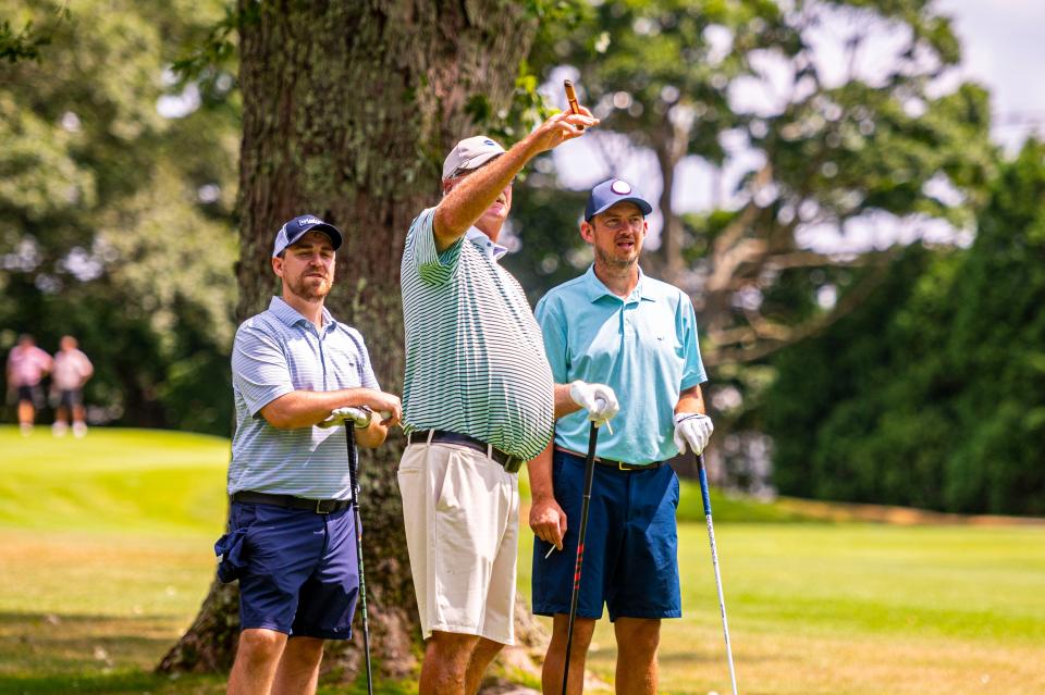 Matt Simmons, Vaughn Wedge and Derek Eilersten look at the layout on hole two at the CCNB Fourball Tournament.