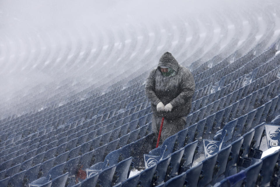 Workers remove snow from Highmark Stadium in Orchard Park, N.Y., Sunday Jan. 14, 2024. A potentially dangerous snowstorm that hit the Buffalo region on Saturday led the NFL to push back the Bills wild-card playoff game against the Pittsburgh Steelers from Sunday to Monday. New York Gov. Kathy Hochul and the NFL cited public safety concerns for the postponement, with up to 2 feet of snow projected to fall on the region over a 24- plus hour period. (AP Photo/ Jeffrey T. Barnes)