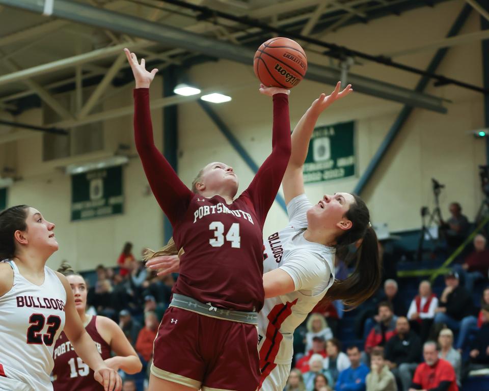 Portsmouth High School's Maddie MacCannell gets a hand on a rebound while Bedford's Lana McCarthy reaches for the ball during the Clippers' 62-35 loss to Bedford in a Division I girls basketball semifinal Tuesday, March 5, 2024 at Exeter High School.