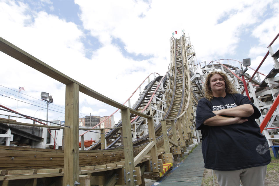 In a Tuesday, June 26, 2012 photo taken on Coney Island in New York, Jennifer Tortorici the operations manager of the Cyclone roller coaster poses for a photo. The New York City landmark and international amusement icon will be feted Saturday, June 30 with a birthday party in its honor. (AP Photo/Mary Altaffer)