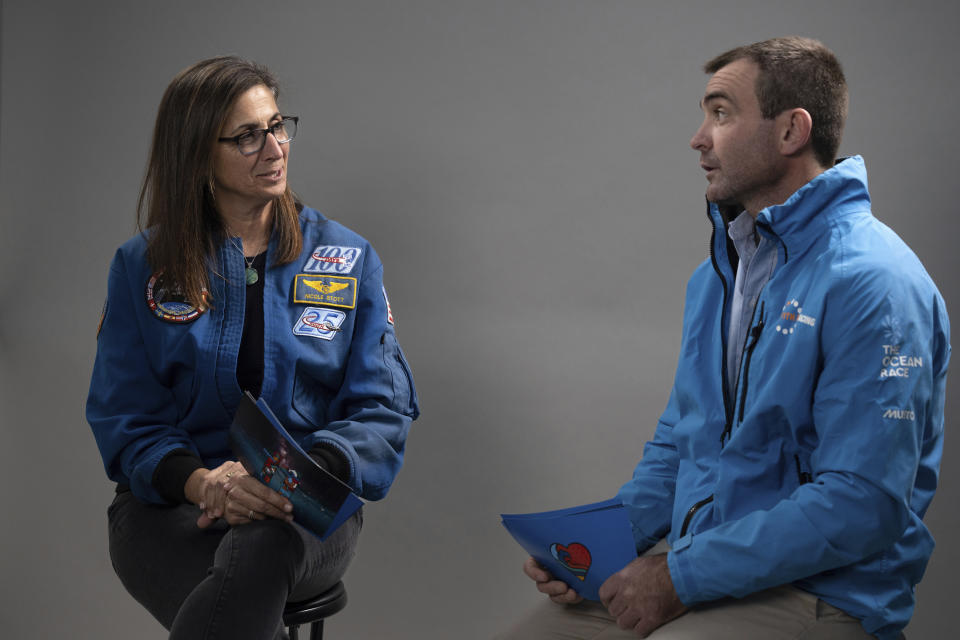 This photo provided by 11th Hour Racing shows former astronaut Nicole Stott and 11th Hour Racing co-founder and skipper Charlie Enright discussing their unique perspectives on ocean health in Providence, R.I., Dec. 19, 2022. Enright is about to lead 11th Hour Racing in the round-the-world Ocean Race, which begins Sunday from Alicante, Spain. (Rane Brower/11th Hour Racing via AP)