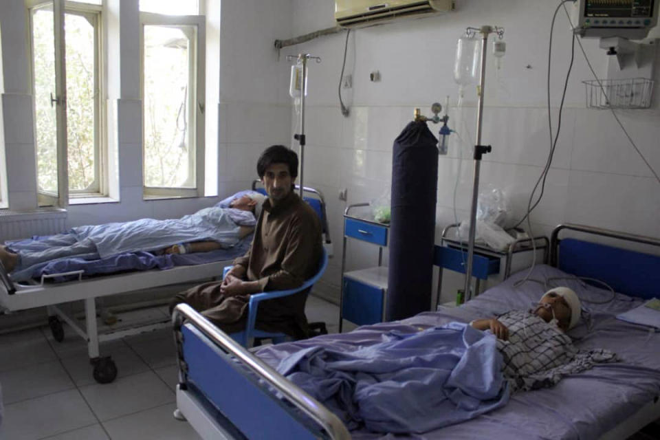 A wounded man and a young boy receive treatment in a hospital, after a fight between Taliban and Afghan security forces in Kunduz province on Saturday, north of Kabul, Afghanistan, Sunday, Sept. 1, 2019. The Taliban attacked a second Afghan city in as many days on Sunday and killed several members of security forces, officials said, even as Washington's peace envoy said the U.S. and the militant group are "at the threshold of an agreement" to end America's longest war. (AP Photo/Bashir Khan Safi)