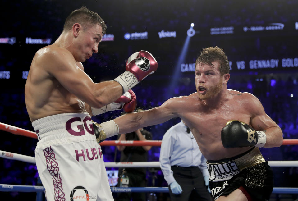 Canelo Alvarez, right, and Gennady Golovkin trade punches in the fourth round during a middleweight title boxing match, Saturday, Sept. 15, 2018, in Las Vegas. (AP Photo/Isaac Brekken)