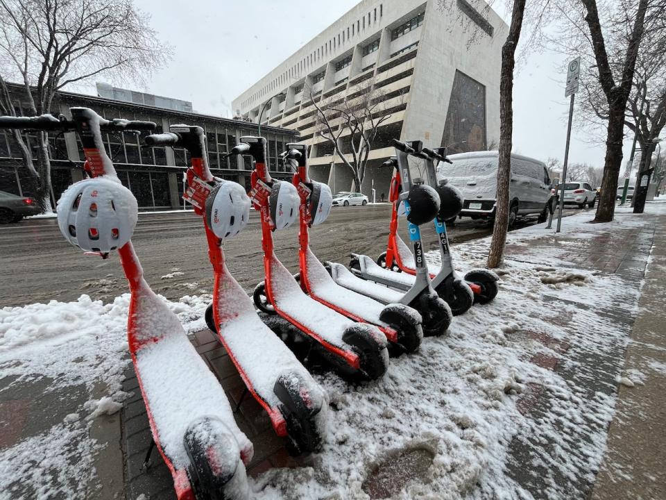 E-scooters, which returned to Saskatoon earlier in the week, were covered in slushy snow on Wednesday.