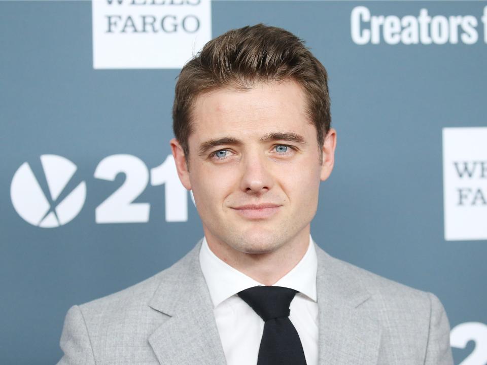 robbie rogers in a suit on the red carpet.