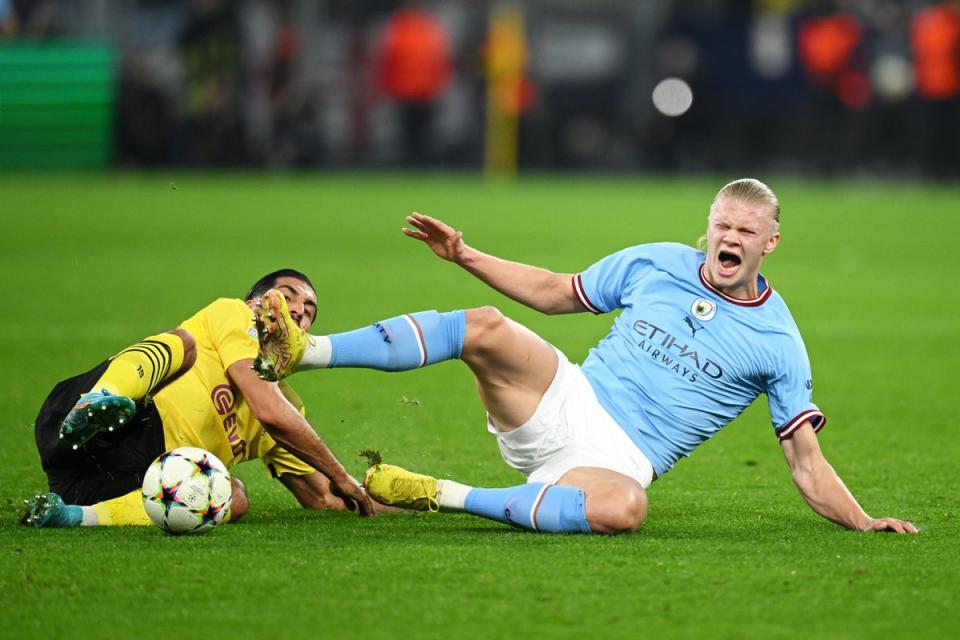Erling Haaland is challenged by Dortmund’s Emre Can (Getty Images)