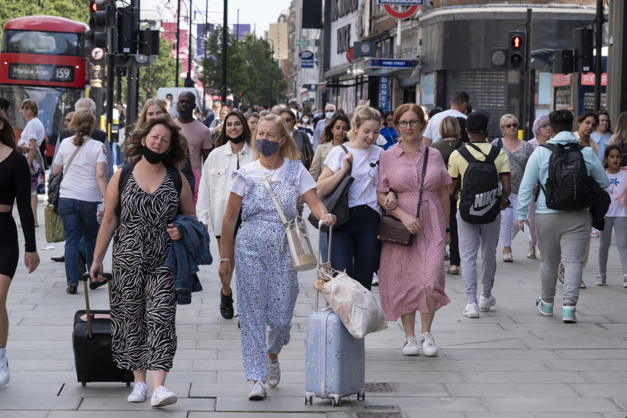 People walking along a busy London shopping street