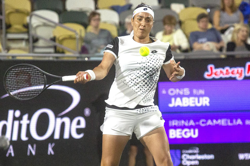 Ons Jabeur returns a shot during her match against Irina-Camelia Bego at the Charleston Open tennis tournament in Charleston, S.C., Thursday, April 7, 2022. Jabeur eliminated Irina-Camelia Begu 6-3, 6-2. (Brad Nettles/The Post And Courier via AP)