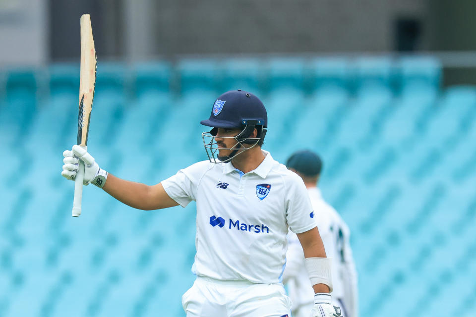 SYDNEY, AUSTRALIA - NOVEMBER 28: Ollie Davies of the Blues raises his bat as he reaches his half century during the Sheffield Shield match between New South Wales and Tasmania at SCG, on November 28, 2023, in Sydney, Australia. (Photo by Mark Evans/Getty Images)