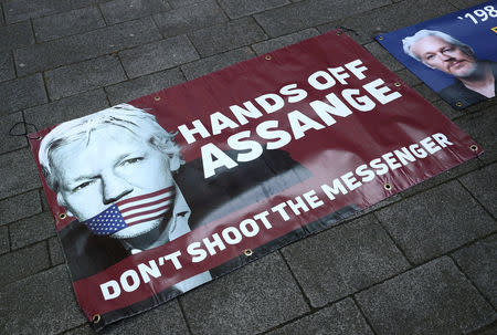 Banners in support of arrested WikiLeaks founder Julian Assange are seen on the pavement in front of Westminster Magistrates Court in London, Britain April 11, 2019. REUTERS/Hannah McKay