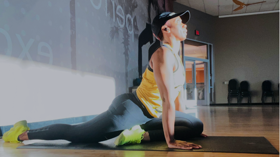 Personal trainer Elethia Gay performs half-pigeon pose