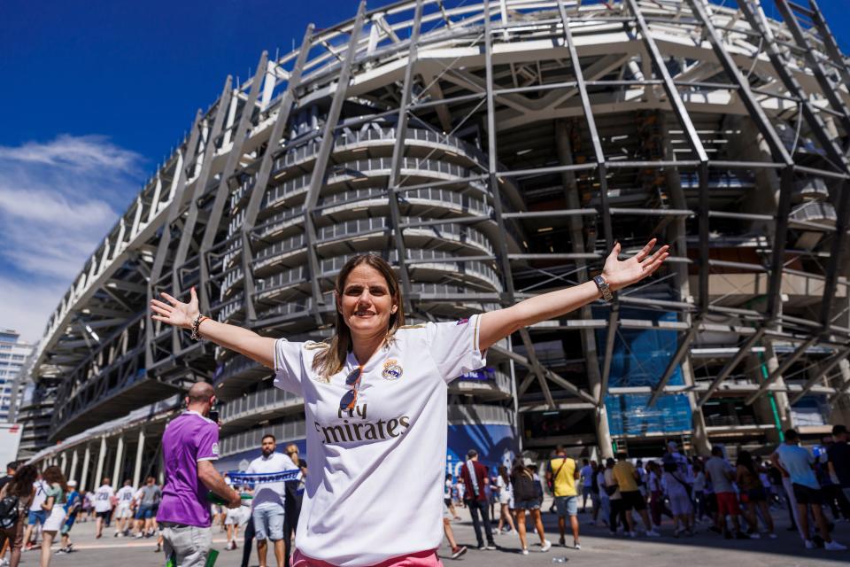 A fan poses outside Real Madrid's home, the Santiago Bernabéu Stadium.