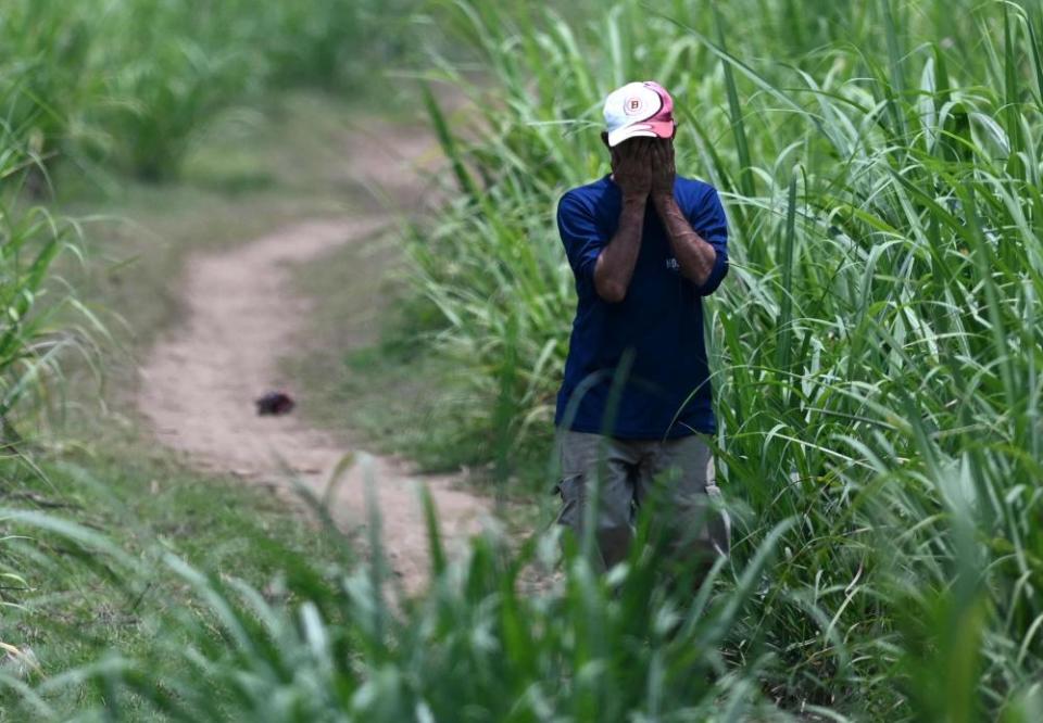 A man is seen near the house of former police officer Hugo Ernesto Osorio in Chalchuapa, El Salvador, last week.