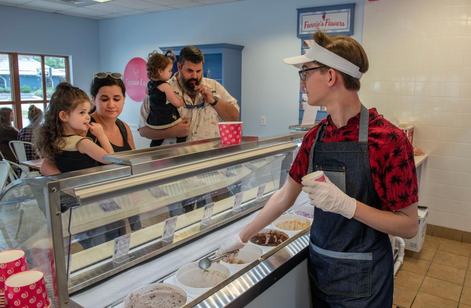 Matthew Miley of Fannie Lou's Ice Cream helps the Galvan family with their ice cream choice.