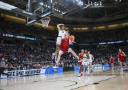 Connecticut guard Andre Jackson Jr. (44) defends against Saint Mary's guard Luke Barrett (33) during the second half of a second-round college basketball game in the NCAA Tournament Sunday, March 19, 2023, in Albany, N.Y. (AP Photo/Hans Pennink)