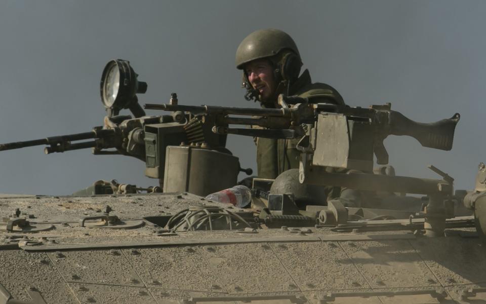 NEAR BE'ERI, ISRAEL - OCTOBER 14: Israeli soldier on a tank that moves near the border with Gaza on October 14, 2023 in Near Sderot, Israel. Israel has sealed off Gaza and launched sustained retaliatory air strikes, which have killed at least 1,400 people with more than 400,000 displaced, after a large-scale attack by Hamas. On October 7, the Palestinian militant group Hamas launched a surprise attack on Israel from Gaza by land, sea, and air, killing over 1,300 people and wounding around 2,800. Israeli soldiers and civilians have also been taken hostage by Hamas and moved into Gaza. The attack prompted a declaration of war by Israeli Prime Minister Benjamin Netanyahu and the announcement of an emergency wartime government. (Photo by Amir Levy/Getty Images)