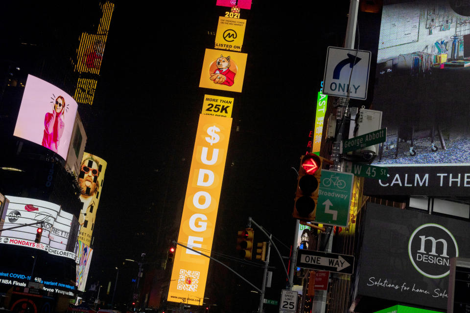 NEW YORK, NEW YORK - JULY 20: A billboard in Times Square displays signs for Dogecoin on July 20, 2021 in New York City. New York City has seen a slow increase of tourism as more people receive the COVID-19 vaccination. The Times Square Alliance reported more than 160,000 tourists in early April 2021, which is a five time increase from the same time the previous year. (Photo by Alexi Rosenfeld/Getty Images)