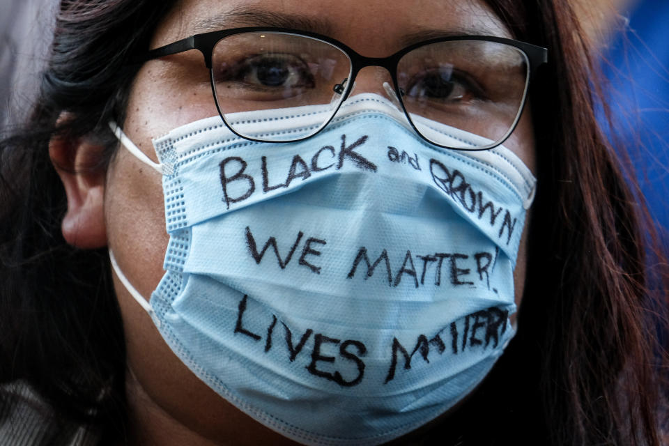 A demonstrator wears a mask with a message during a protest of the death of George Floyd, a black man who was in police custody in Minneapolis, in downtown Los Angeles, Wednesday, May 27, 2020. (AP Photo/Ringo H.W. Chiu)