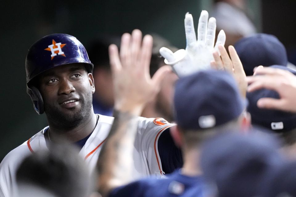 Houston Astros' Yordan Alvarez, left, celebrates in the dugout after scoring a run during the fourth inning of a baseball game against the Chicago Cubs Tuesday, May 16, 2023, in Houston. (AP Photo/David J. Phillip)