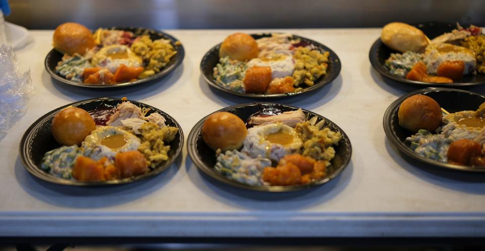 Plates of food are ready for delivery Wednesday, Nov. 23, 2022, during a Thanksgiving meal at the Homeless Alliance Wednesday.