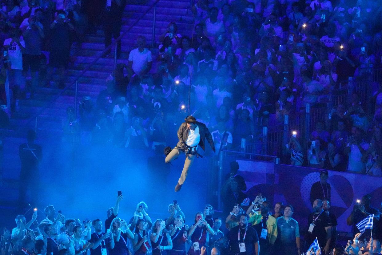 Tom Cruise is lowered into the stadium during the 2024 Summer Olympics closing ceremony at the Stade de France, Sunday, Aug. 11, 2024, in Saint-Denis, France. (AP Photo/Martin Meissner)