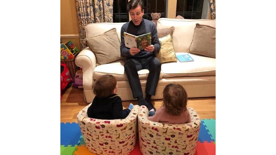 anton reading book to twin children