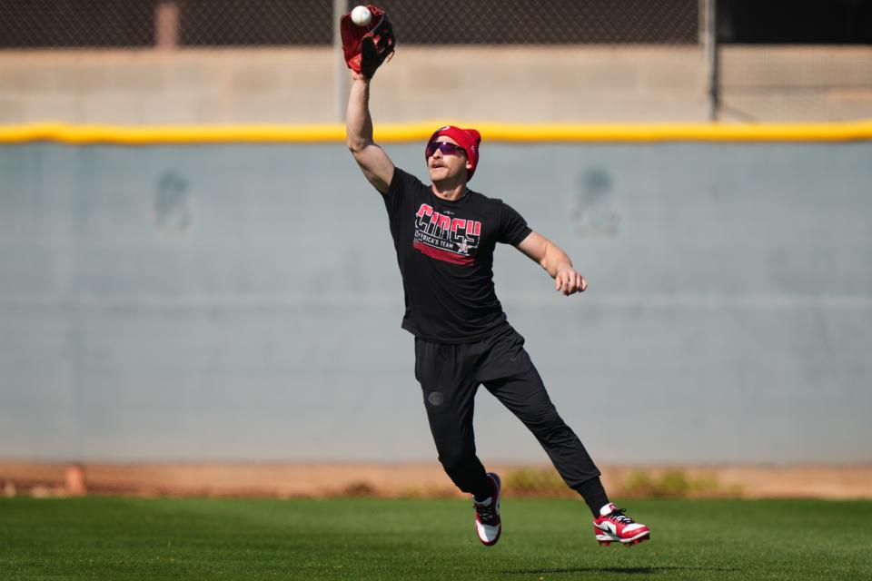 Cincinnati Reds center fielder TJ Friedl (29) catches a fly ball during spring training workouts, Thursday, Feb. 15, 2024, at the team’s spring training facility in Goodyear, Ariz.