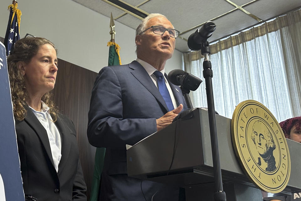 Washington Gov. Jay Inslee speaks to reporters during a news conference in Seattle, Tuesday, June 11, 2024, as abortion rights supporters listen. Inslee announced that Washington state will spell out in state law that hospitals must provide abortions if needed to stabilize patients, a step that comes as the U.S. Supreme Court is expected to rule this month on whether conservative states can bar abortions during some medical emergencies. (AP Photo/Gene Johnson)