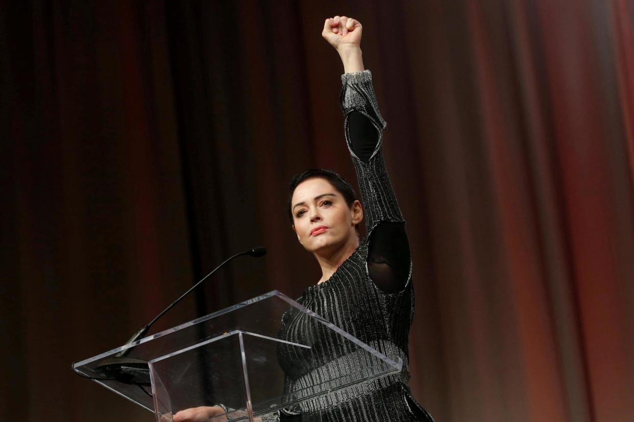 Actor Rose McGowan raises her fist after addressing the audience during the opening session of the three-day Women's Convention in Detroit, October 2017: Reuters