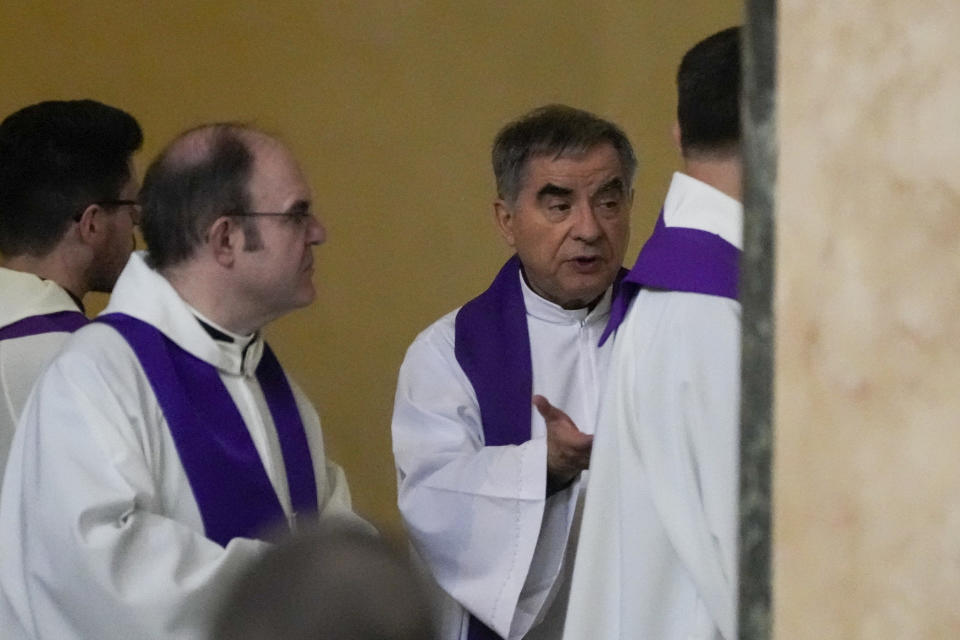 Cardinal Angelo Becciu, right, arrives to attend a mass presided by Pope Francis at the Santa Maria delle Grazie parish church, in Rome, Friday, March 17, 2023. Lawyers for the once-powerful cardinal have accused Vatican prosecutors of being “prisoners to their completely shattered theory" in closing arguments of a two-year trial. Becciu is on trial along with nine other people in a case that is focused on the Vatican’s 350 million-euro investment in a London property. (AP Photo/Gregorio Borgia)