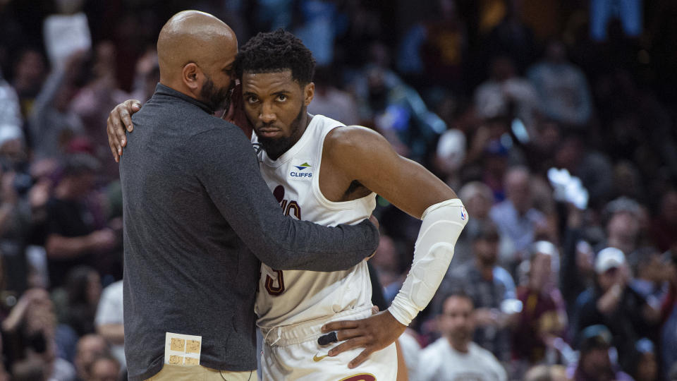 Cleveland Cavaliers coach J.B. Bickerstaff gives Donovan Mitchell a hug during the second half of Game 5 of the team's NBA basketball first-round playoff series against the New York Knicks, Wednesday, April 26, 2023, in Cleveland. The Knicks won 106-95 and took the series. (AP Photo/Phil Long)