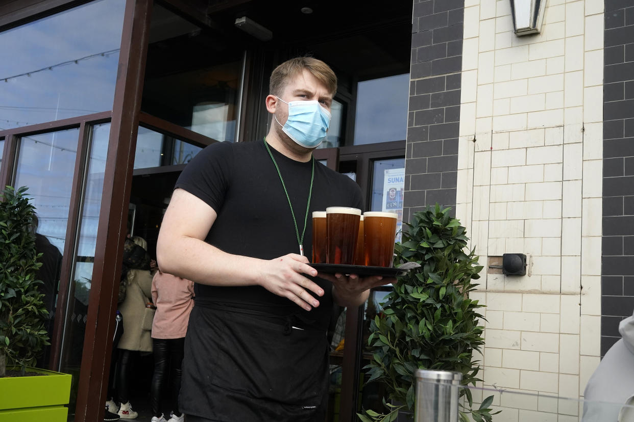 BLACKPOOL, ENGLAND - OCTOBER 16: A barman serves drinks at a Wetherspoon pub on the promenade on October 16, 2020 in Blackpool, England. The Lancashire region will go into Tier 3 of Covid-19 lockdown restrictions from 00.01 Saturday 17th October. (Photo by Christopher Furlong/Getty Images)