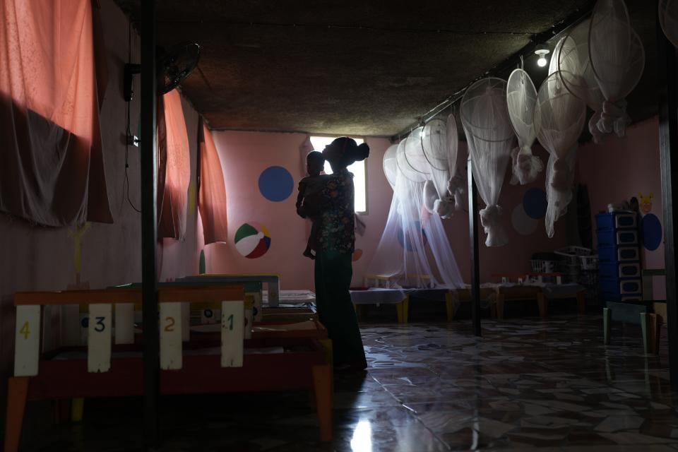 A health worker holds a toddler at the Fontaine Hospital Center which treats malnourished children in the Cite Soleil area of Port-au-Prince, Haiti, Monday, May 29, 2023. Two U.N. agencies have warned of rising food emergencies including starvation in Haiti due to restricted movements of people and goods. (AP Photo/Ariana Cubillos)