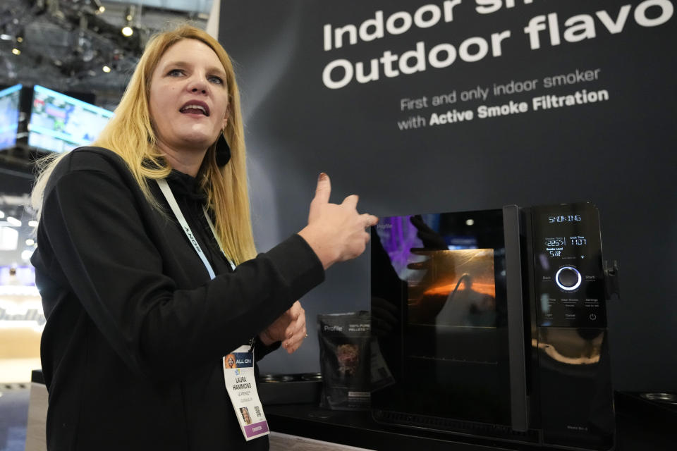 Laura Hammond, GE Profile, speaks while giving a demonstration of the company's new electric and smokeless smoker during the CES tech show Wednesday, Jan. 10, 2024, in Las Vegas. (AP Photo/Ryan Sun)