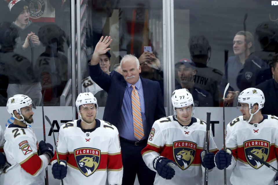 Florida Panthers head coach and former Chicago Blackhawks coach, Joel Quenneville acknowledges the crowds applause during the first period of an NHL hockey game between the Blackhawks and Panthers, marking Quenneville's return as a head coach Tuesday, Jan. 21, 2020, in Chicago. (AP Photo/Charles Rex Arbogast)