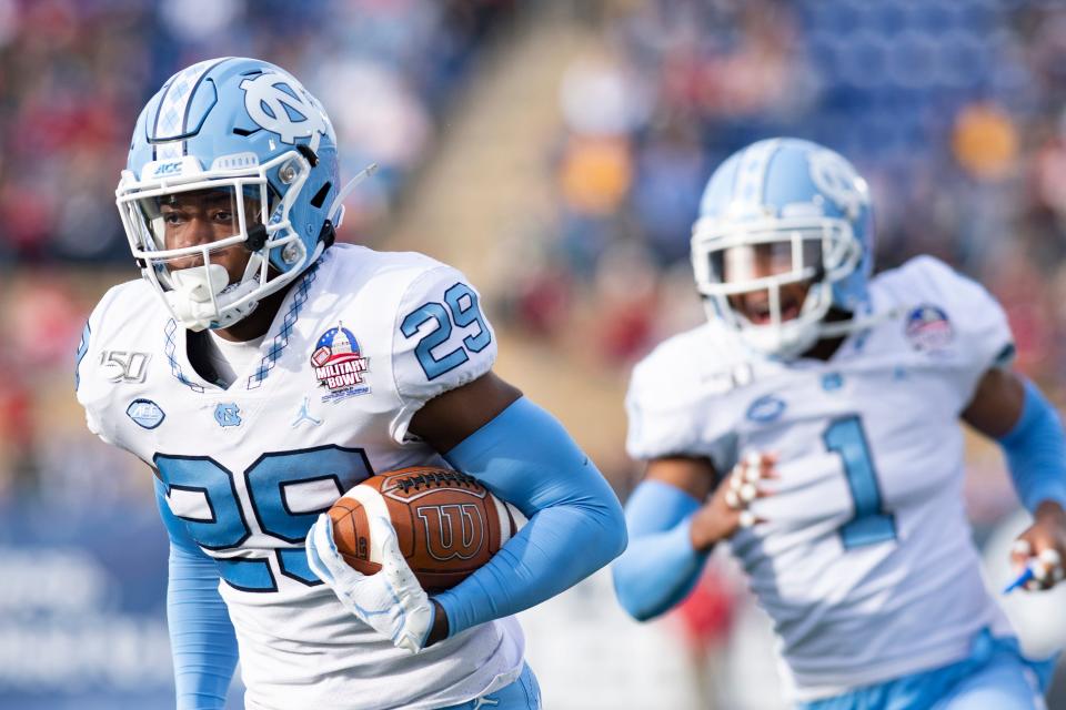 Dec 27, 2019; Annapolis, Maryland, USA;  North Carolina Tar Heels defensive back Storm Duck (29) returns an interception for a touchdown as  defensive back Myles Dorn (1) celebrates during the third quarter against the Temple Owls at Navy-Marine Corps Memorial Stadium. Mandatory Credit: Tommy Gilligan-USA TODAY Sports