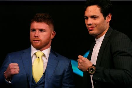 Mexico's boxers Canelo Alvarez, (L), and Julio Cesar Chavez, Jr (R), pose for a photograph during a news conference ahead of WBC brawl in Las Vegas, in Mexico City, Mexico, February 20, 2017. REUTERS/Carlos Jasso