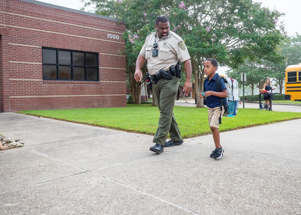 School resource officer Deputy Wilson Francis welcomes Students as they arrive at J Wallace James Elementary for first day of School Thursday, Aug. 11, 2022.