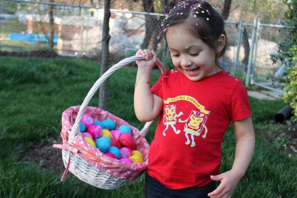 In this March 21, 2012 image released by Cynthia Leonor Garza, Kalila Peralta, 2, plays with cascarones in the back yard of her Washington, D.C., home. Cascarones are hollowed-out eggs that are dyed, decorated and filled with confetti, then covered with a colorful piece of tissue paper. At Easter time, families make or buy cascarones, which is Spanish for "eggshells," for crushing over each other's heads. The tradition came to the United States from Mexico, where cascarones were used during fiestas and other celebrations. In the United States, it has become primarily an Easter tradition. (AP Photo/Cynthia Leonor Garza)