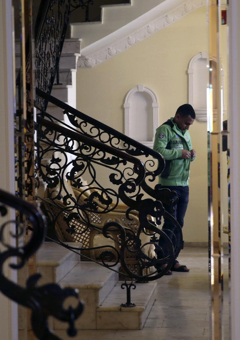 Gaza comedian Adel al-Mashwakhi adjusts his clothes in front of a mirror before an interview with The Associated Press, in Gaza City, Thursday, Jan. 26, 2017. Gaza’s Hamas rulers have released al-Mashwakhi who was arrested two weeks ago for posting a Facebook video lamenting hardships under its rule. Adel al-Mashwakhi says he was released on bail on Wednesday on the condition that he does not make any more “politically flavored” works or discuss the conditions in which he was held. (AP Photo/Adel Hana)