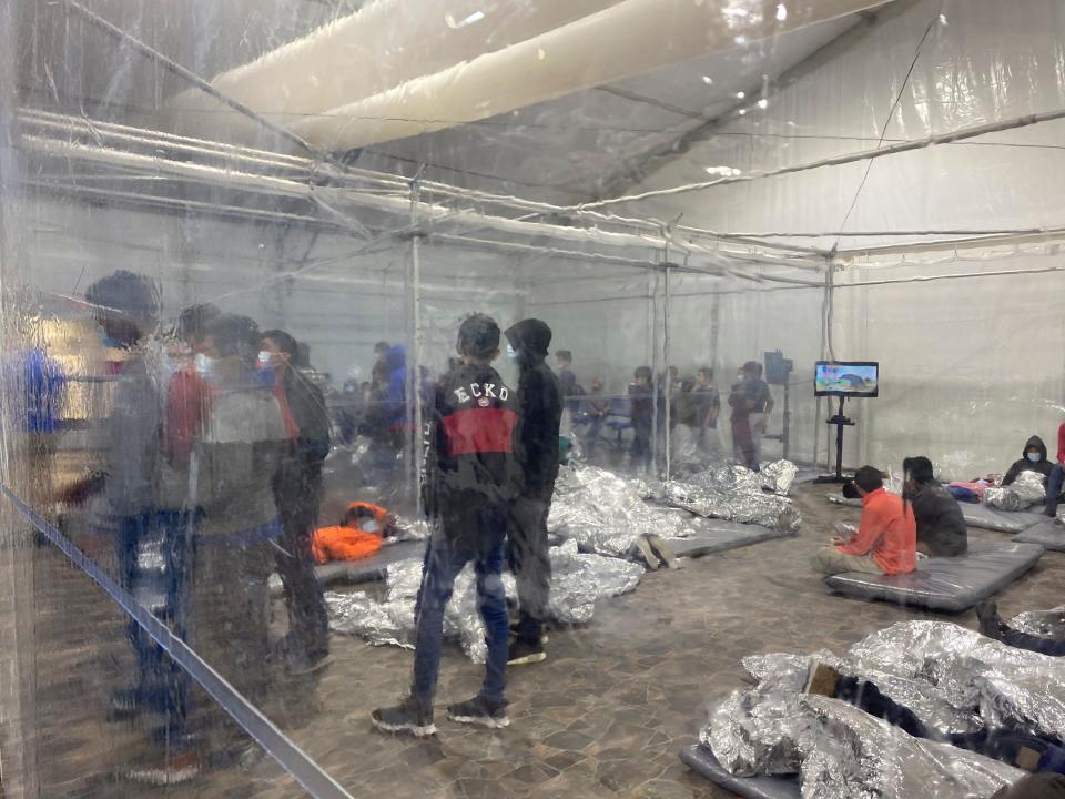 This March 20, 2021, photo provided by the office of Rep. Henry Cuellar, D-Texas, shows detainees in a Customs and Border Protection temporary overflow facility in Donna, Texas. President Joe Biden's administration faces mounting criticism for refusing to allow outside observers into facilities where it is detaining thousands of immigrant children.  (Photo courtesy of the Office of Congressman Henry Cuellar via AP)