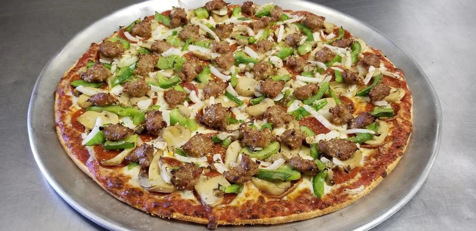 The Classic Supreme pizza with provolone cheese, pepperoni, sausage, mushroom, onion and green pepper from Classic Pizza.