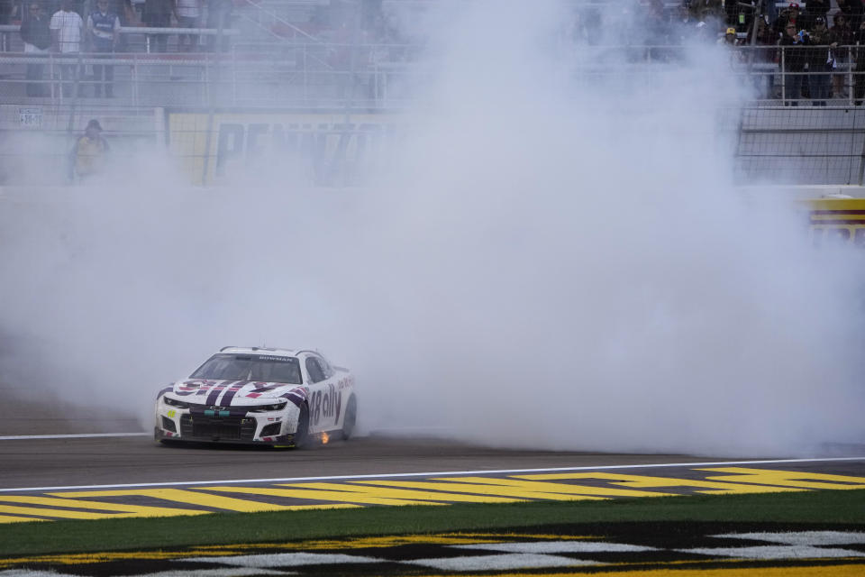 Alex Bowman (48) does a burnout after winning a NASCAR Cup Series auto race Sunday, March 6, 2022, in Las Vegas. (AP Photo/John Locher)