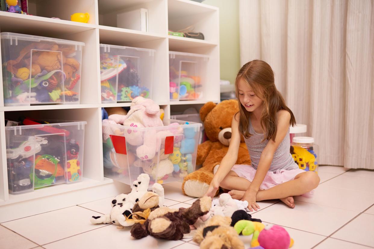 little girl playing with stuffed animals