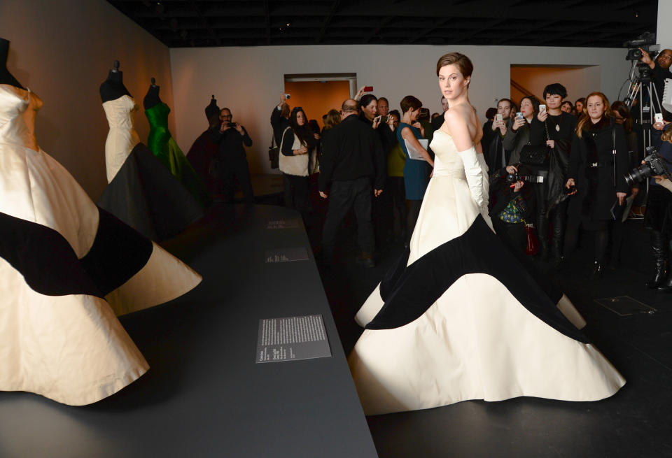 In this photo provided by The Metropolitan Museum of Art, Elettra Wiedemann models a modern day reproduction of a Charles James 1953 Clover Leaf Gown, original shown at left, during a press presentation for the upcoming Costume Institute exhibition, "Charles James: Beyond Fashion," Monday, Feb. 10, 2012, at The Metropolitan Museum of Art in New York. The exhibit runs from May 8 through Aug 10. (AP Photo/Metropolitan Museum of Art and BFAnyc.com, Joe Schildhorn)