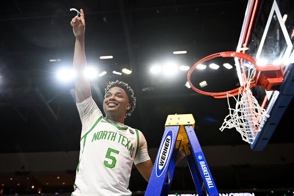 Former North Texas guard Tylor Perry (5) cuts down the net after the Mean Green beat UAB in the NIT championship game last month in Las Vegas.